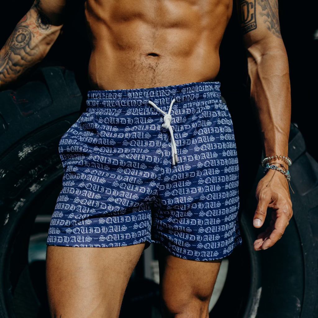 An athletic man wearing 4 inch inseam mesh shorts in navy blue from SquidHaus