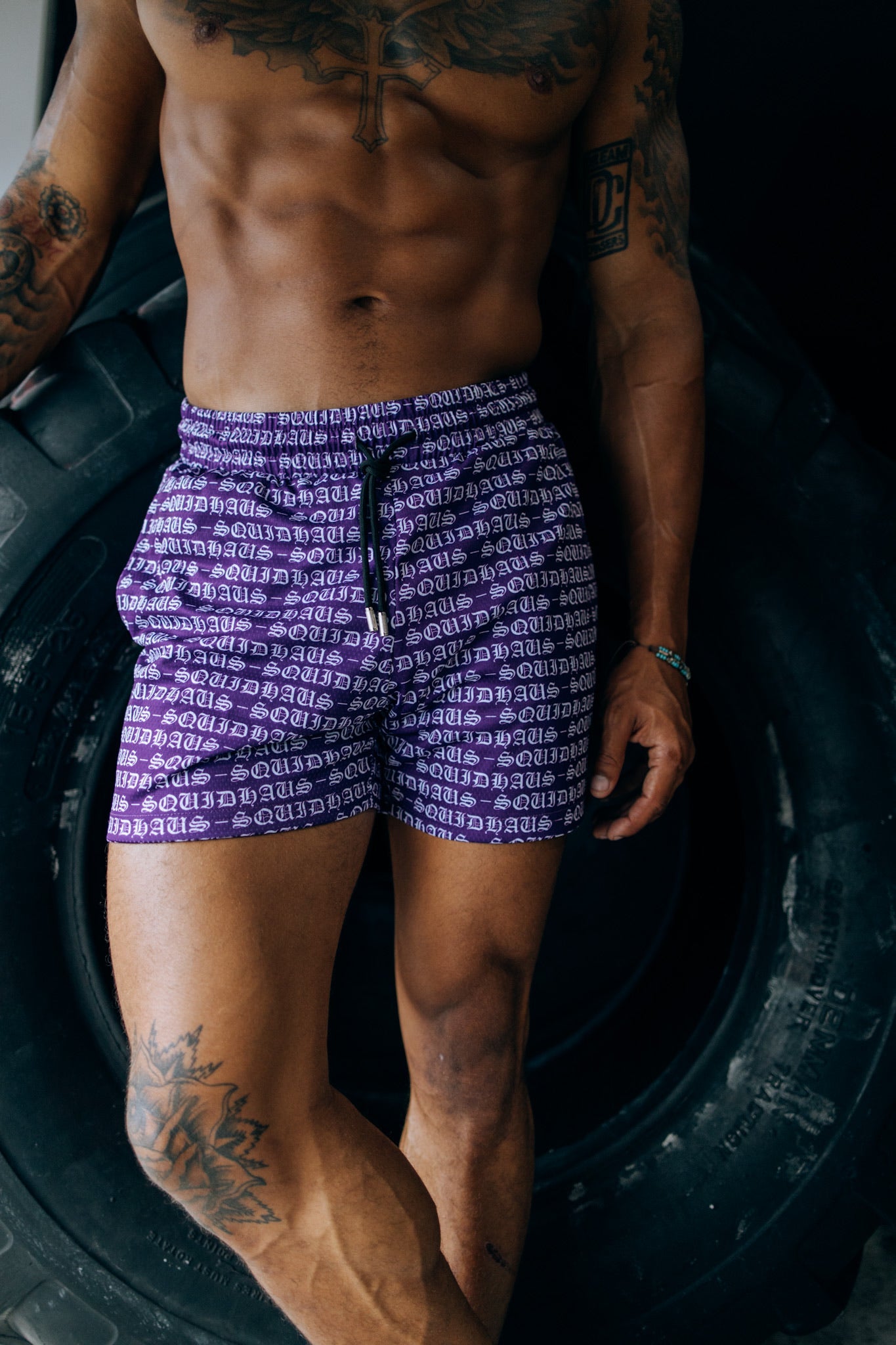 An athlete wearing 4 inch inseam mesh shorts in purple, from SquidHaus