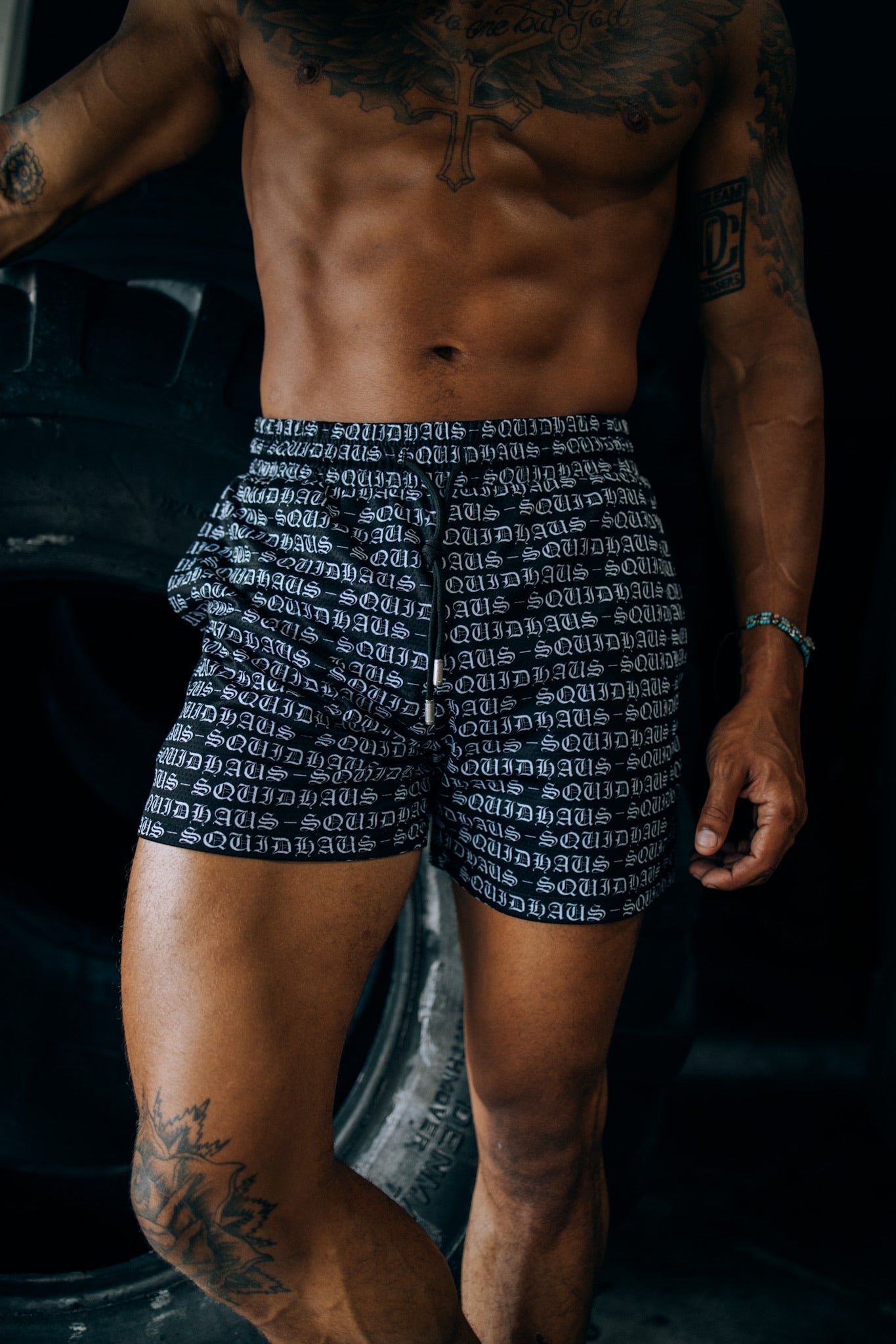 An athlete wearing 4" inseam mesh shorts in black, from SquidHaus