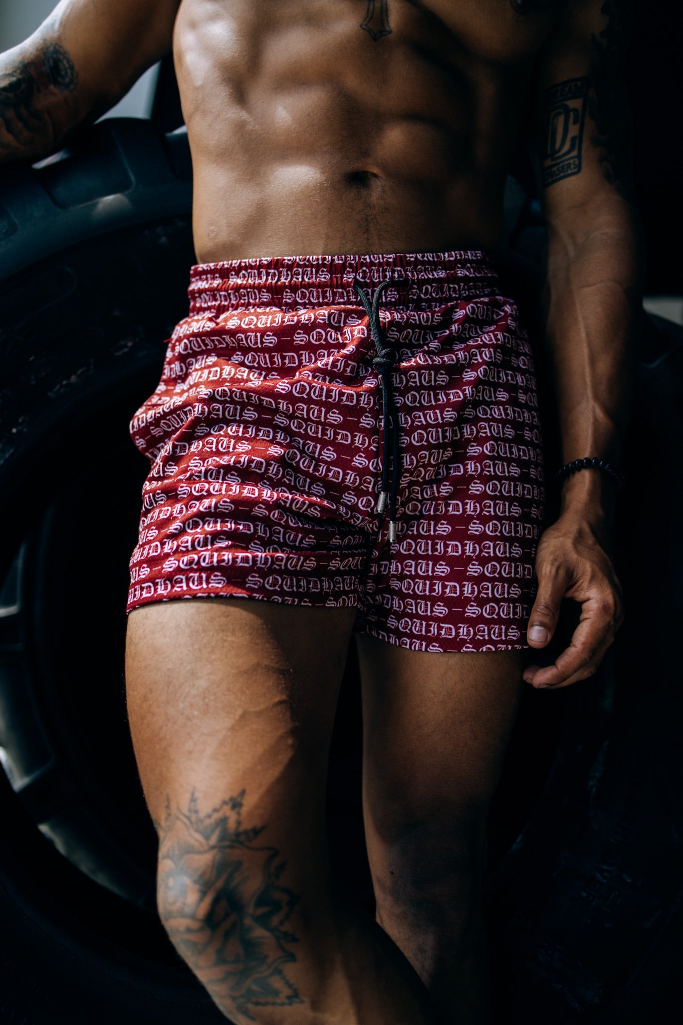 An athlete wearing 4 inch inseam mesh shorts in red, from SquidHaus