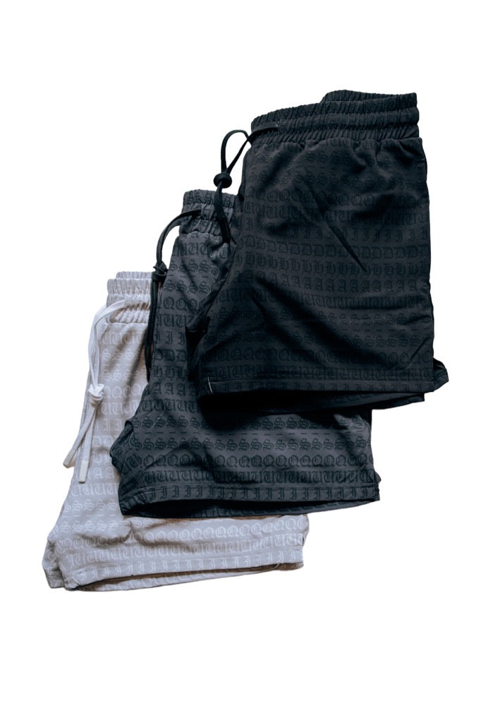 A 3 pack of men's 4 inch inseam mesh shorts in white, gray and black, from SquidHaus